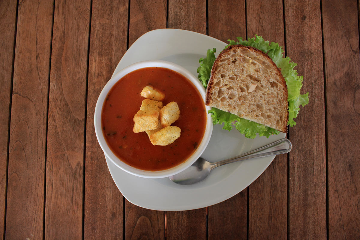 Picture of a food plate, featuring a sandwich and bowl of tomato soup, served at Latte Da